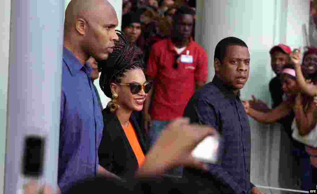 La cantante estadounidense Beyoncé (c) y su esposo, el rapero Jay-Z (i) salen hoy, jueves 4 de abril de 2013, del Hotel Saratoga en La Habana (Cuba), donde se hospedan junto a varios miembros de su familia, para celebrar los cinco años de su matrimonio. E