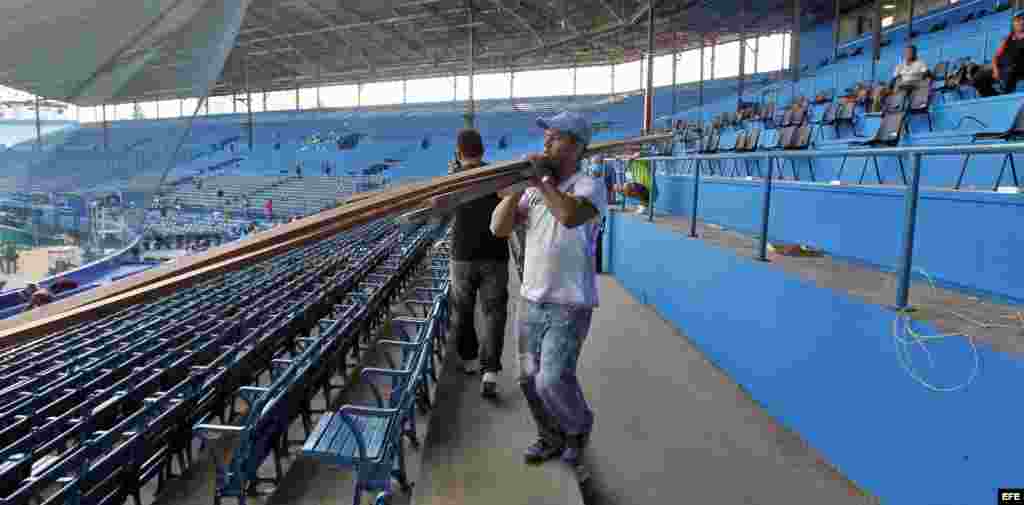 Trabajadores del estadio Latinoamericano de béisbol realizan labores de reparación para el encuentro de una selección cubana de béisbol y el equipo Rays de Tampa Bay.