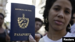 Una cubana muestra su pasaporte cubano obtenido en una oficina de inmigración en La Habana, Cuba 